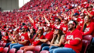 Athletic fans in stadium seats wearing Fresno State colors, cheering with enthusiasm during an exciting college football game moment