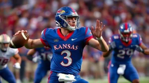 College football quarterback in mid-throw motion, wearing Kansas Jayhawks uniform, against blurred defensive pressure from opposing players, stadium lights in background, focused intensity on face