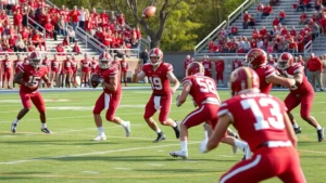 College football team in crimson uniforms executing offensive play during daytime stadium game, quarterback throwing downfield, defensive players pursuing