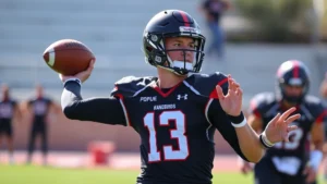 College football quarterback in practice uniform throwing football during Southern Utah Thunderbirds team training session, focused expression, athletic movement, outdoor field setting, professional sports photography